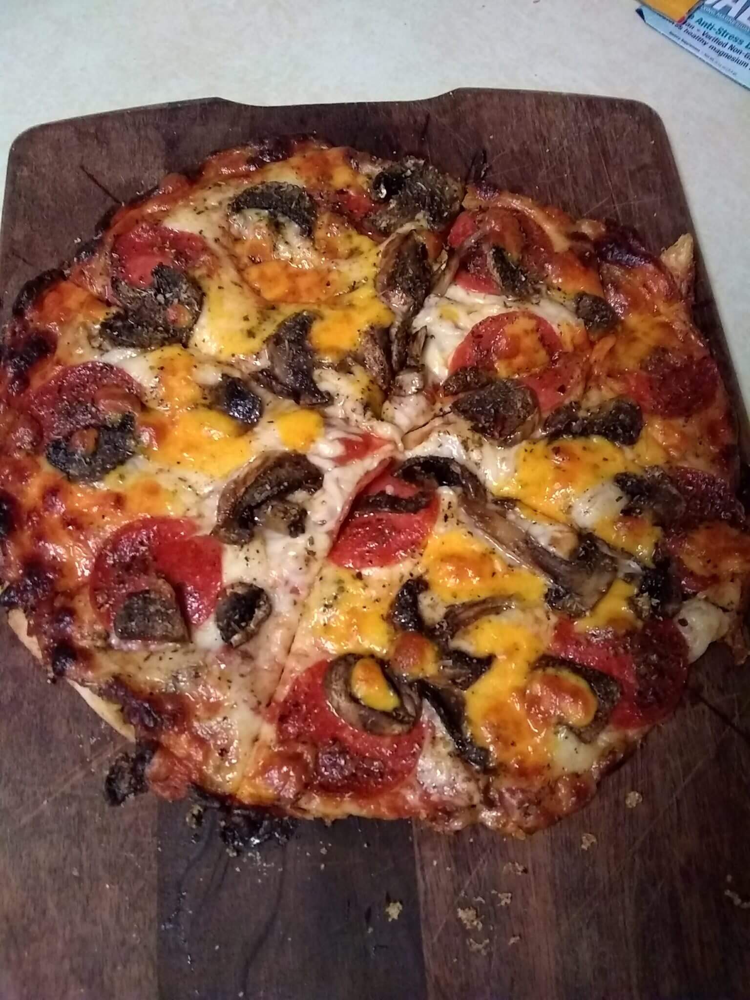 Tortilla pepperoni and mushroom pizza